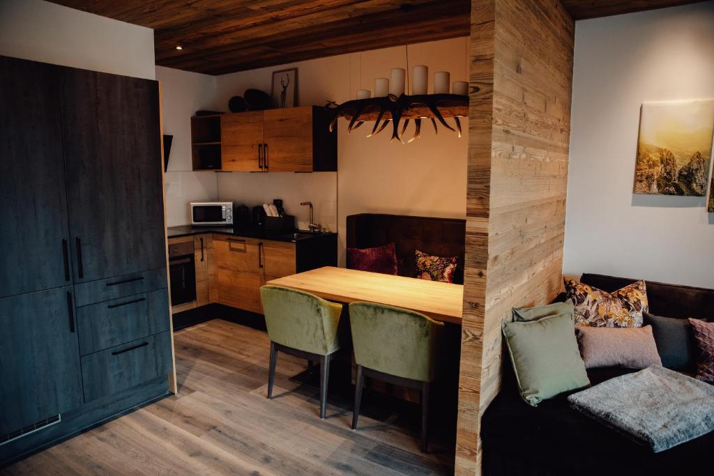 a kitchen and dining room with a wooden table and chairs at Zillertal Juwel in Fügen