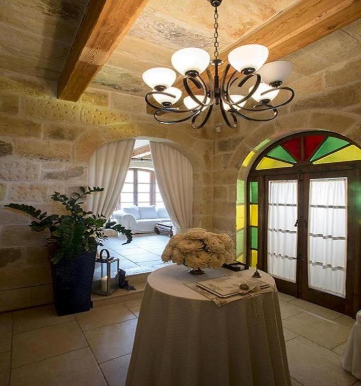 a teddy bear sitting on a table in a room at Betty Cake B&B in Qala