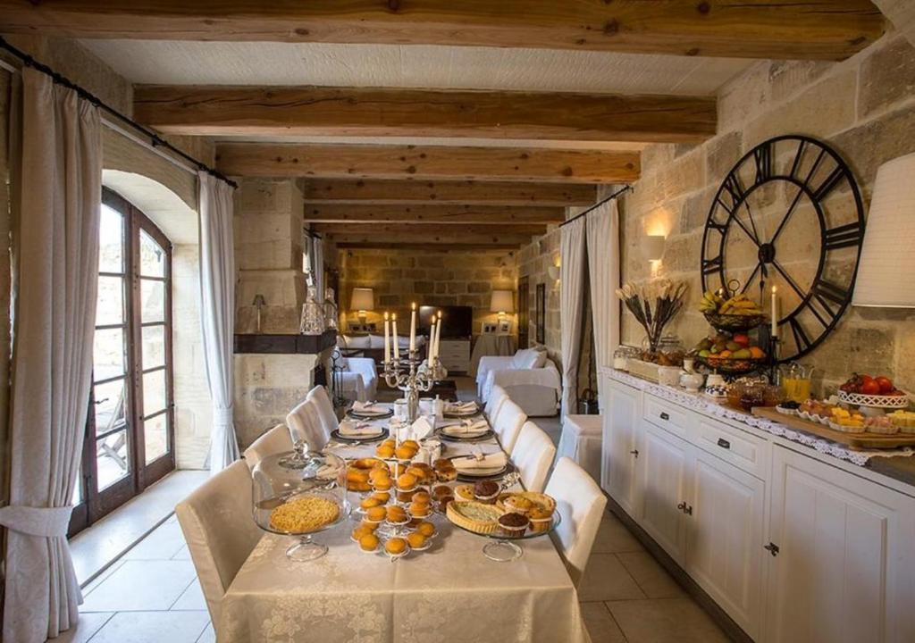 a long table with food on it in a kitchen at Betty Cake B&B in Qala
