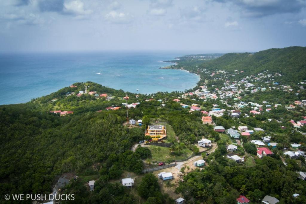an aerial view of a town on a hill next to the ocean at Belle View Apartment Villas in Laborie