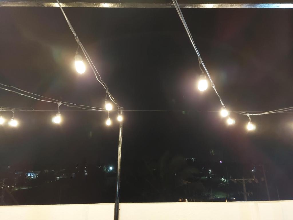 a group of lights hanging from a tent at night at Kua's Pad in Tagaytay