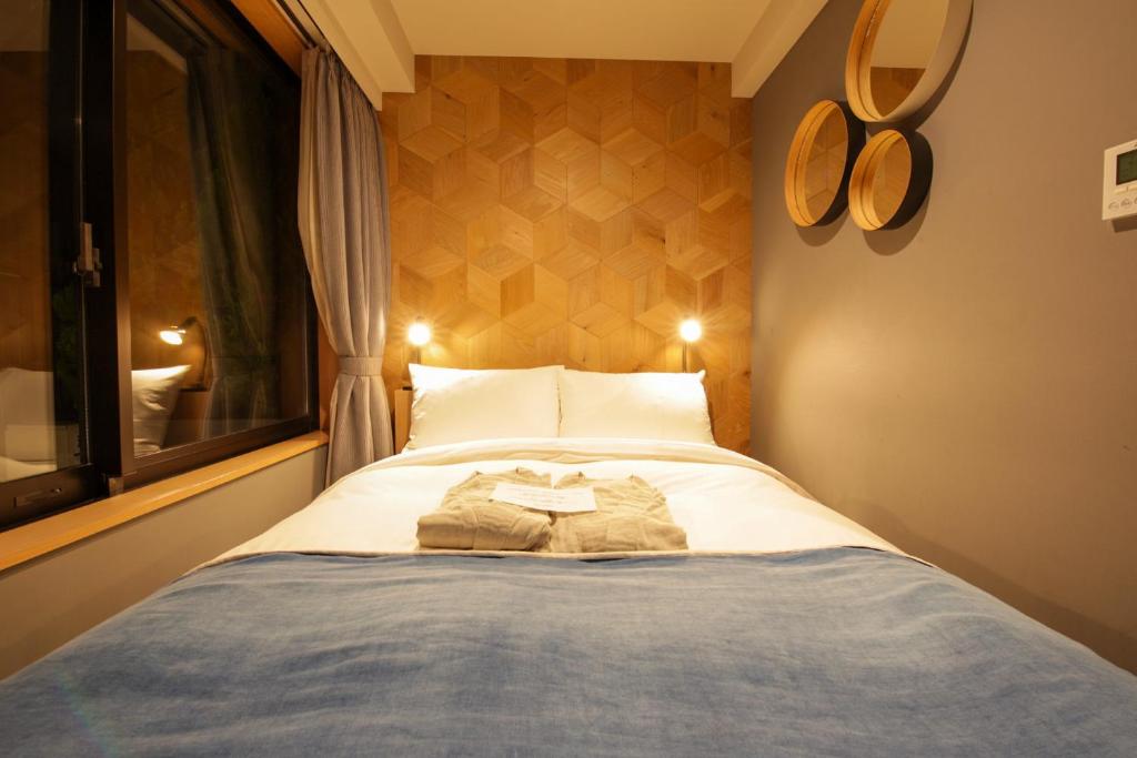 Postel nebo postele na pokoji v ubytování Asakusa Kokono Club Hotel