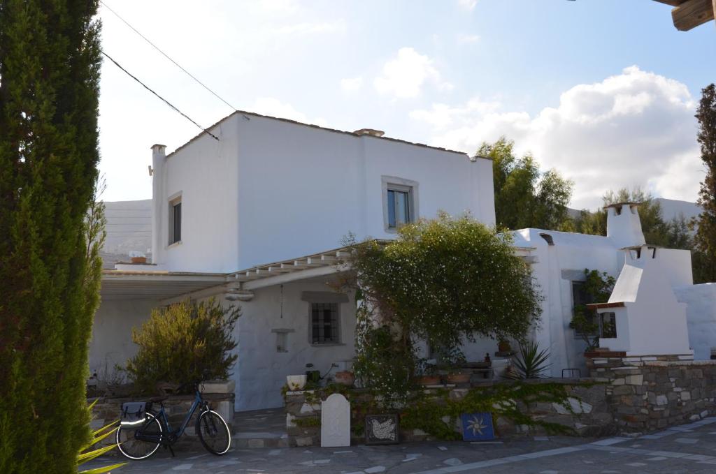 a white house with two bikes parked in front of it at Paros Traditional Country House in Parikia