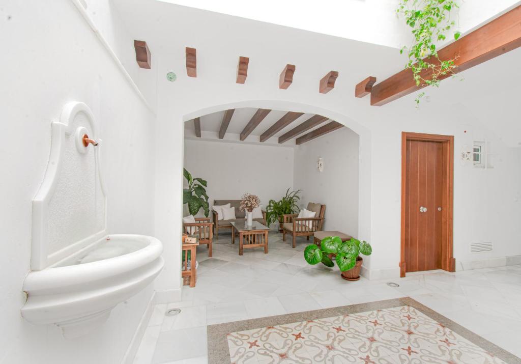 a bathroom with a toilet and a living room at 7Escalones in Rota