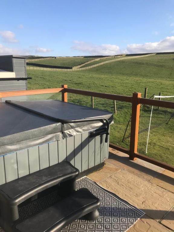 a ping pong table on a deck with a view of a field at Breeze Place in Nelson