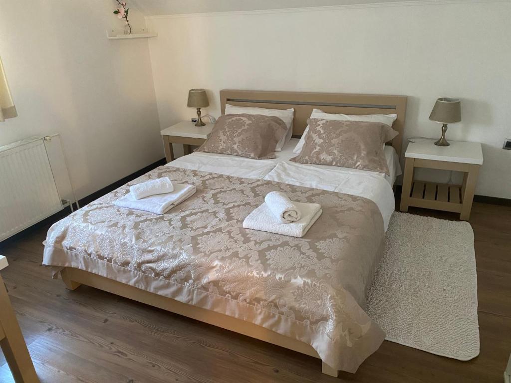a bedroom with a bed with two towels on it at APARTMAN NEVENKA in Rakovica