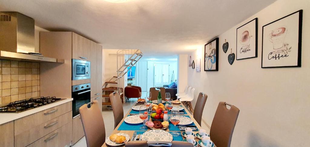 a kitchen with a long table with food on it at Pieno Centro Apartment in Tropea