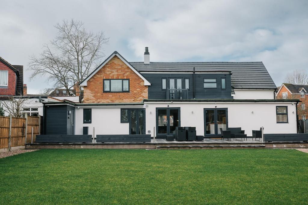 a black and white house with a yard at The White House - Grand & Spectacular 5-bed, sleeps 14- Central Solihull, NEC, JLR, HS2, Resorts World, Airport in Solihull