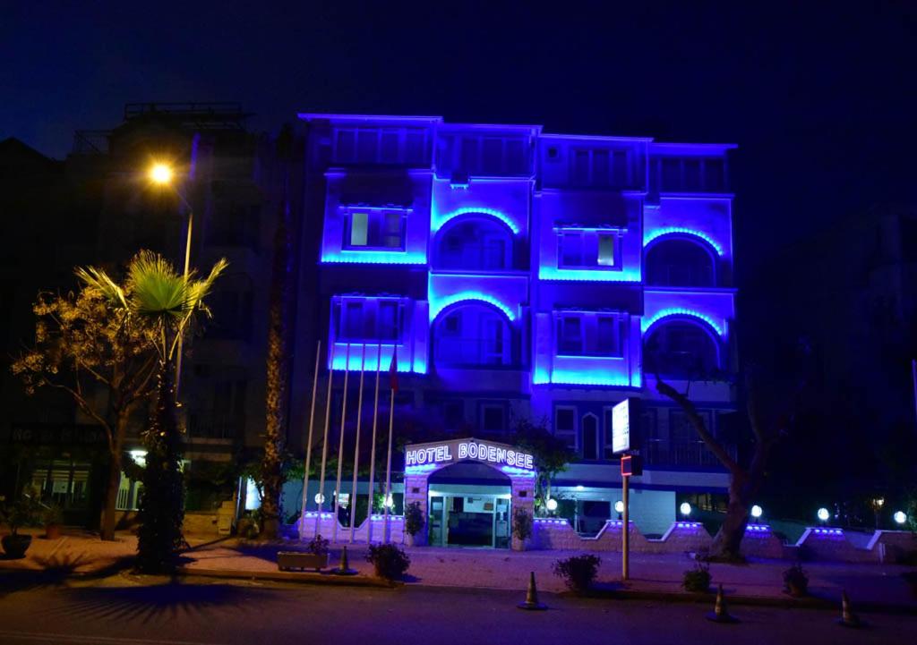 a building with blue lights on it at night at BODENSEE HOTEL in Antalya