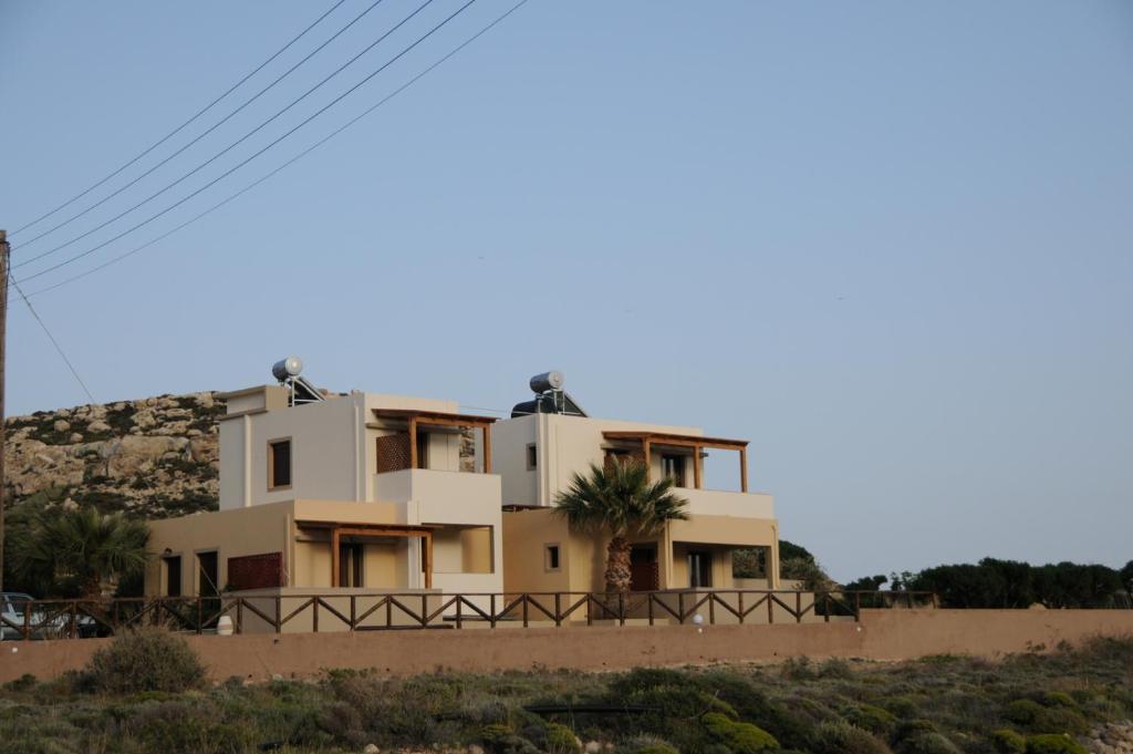 a house on the side of a hill at AEOLUS Studios in Xerokampos