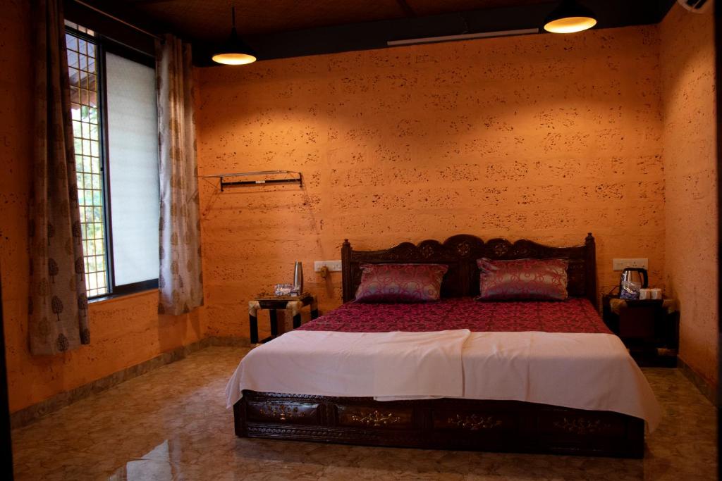 a bedroom with a large bed in a room at amee's retreat in Diveagar