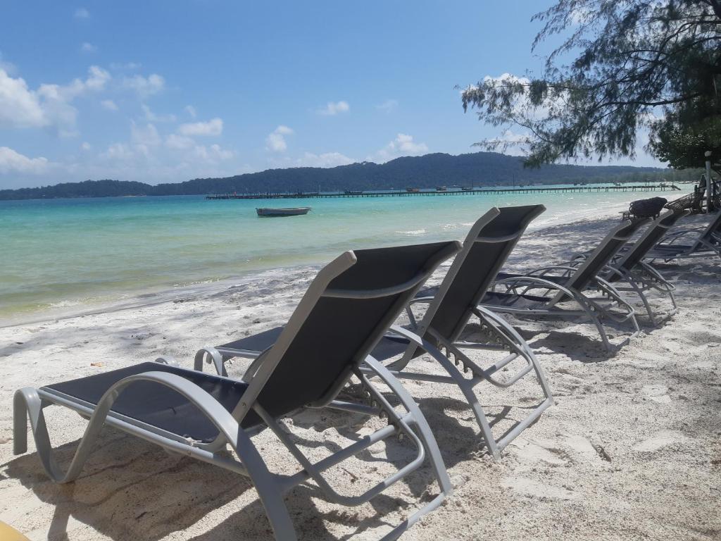 a group of chairs sitting on the beach at Sunny Bungalow in Koh Rong Sanloem