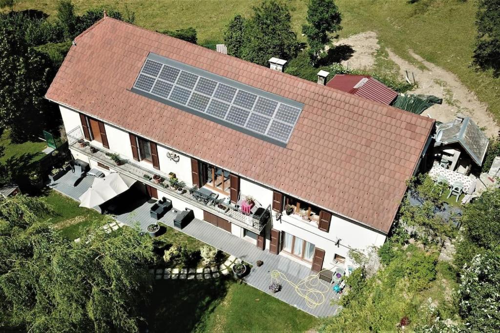 an aerial view of a house with a solar roof at Gite Agnès & J-Pierre en étage Evasion spa option in Pierre-Châtel