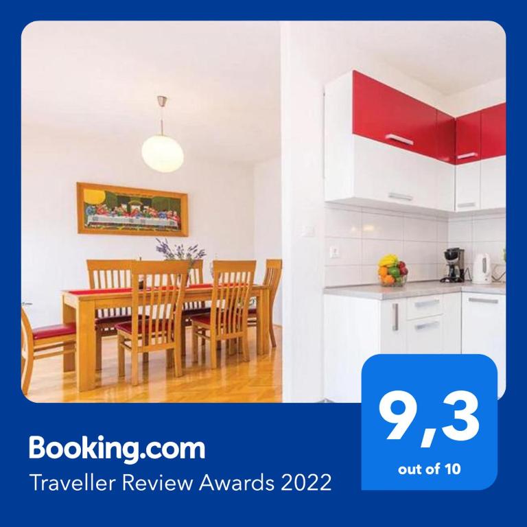 a kitchen and dining room with a table and chairs at Big White apartment in Novi Vinodolski