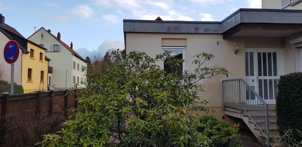 a house with a tree in front of it at Monteurswohnung Tim in Zweibrücken