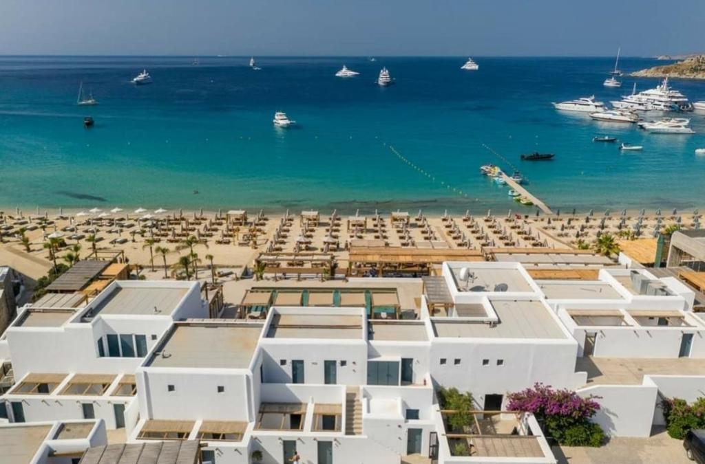 a view of a beach with white buildings and the ocean at La Playa Studio Best location close to the Beach & center in Platis Yialos Mykonos