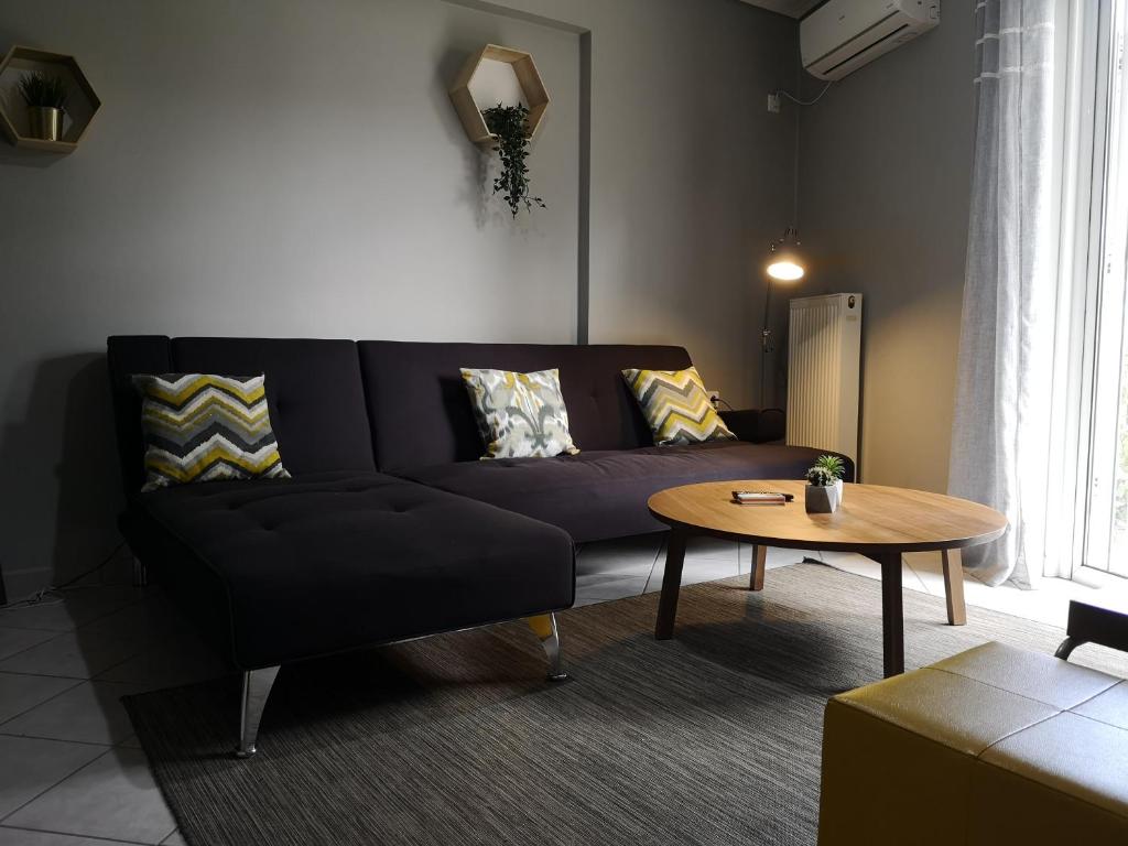 a living room with a couch and a table at Athenian apartment in Agia Paraskevi, next to "Plakentias" metro station in Athens