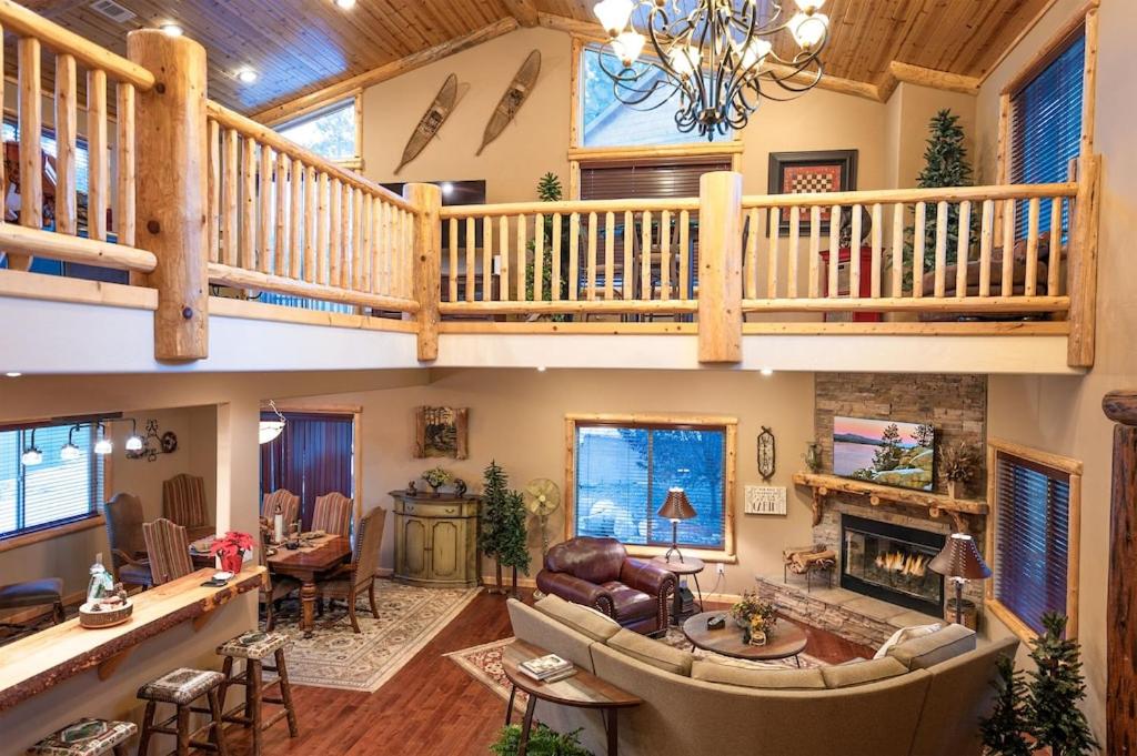 a large living room with a loft with a staircase at Luxury Cabin-Walk to Bear Mountain Resort, Trails & Golf in Big Bear Lake