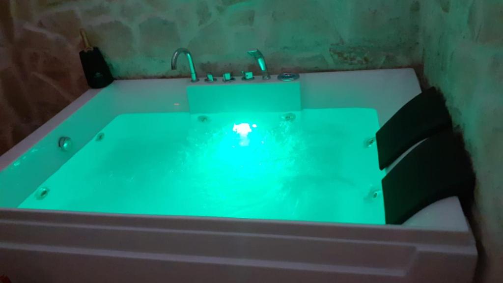 a bath tub with a green bathtub at Apulia lux in Taranto