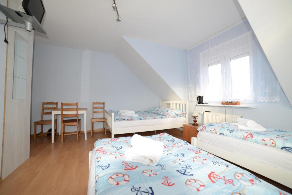 Postel nebo postele na pokoji v ubytování Dom Gościnny Piotr