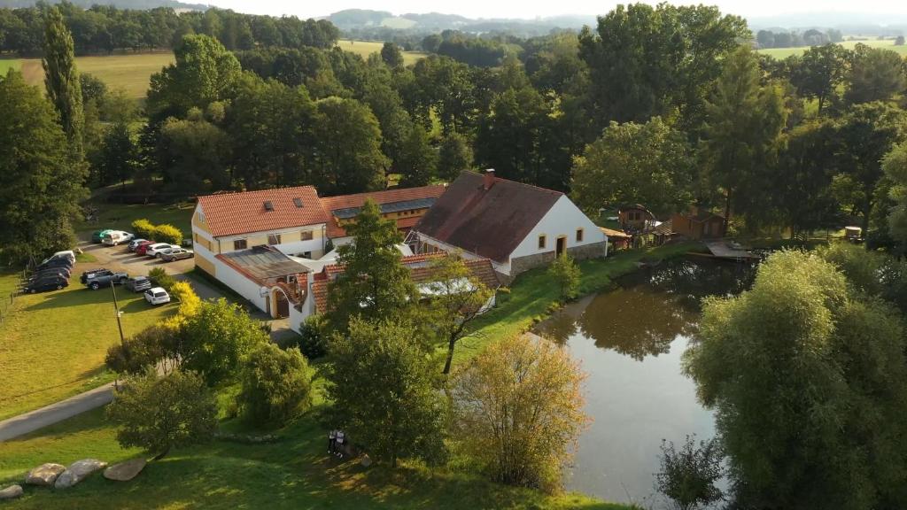 an aerial view of a house next to a lake at Strnadovský mlýn in Jesenice