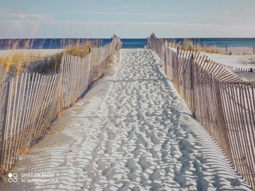 a wooden path through the sand on a beach at Nadmorski Apartament Dream w Gdańsku in Gdańsk