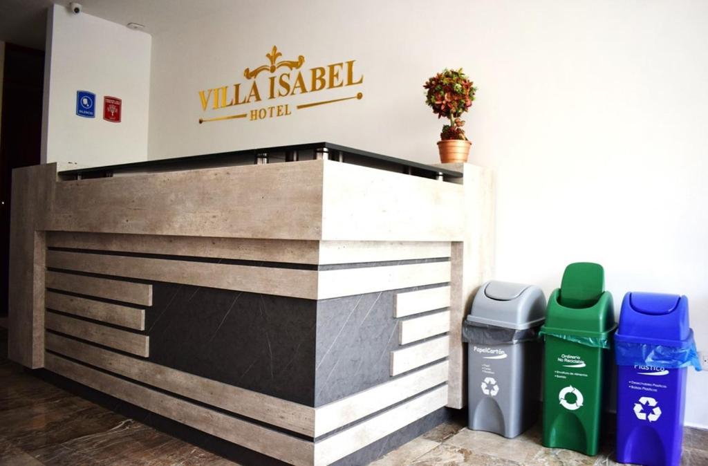 a fireplace with two trash cans in front of a building at Hotel Villa Isabel in Pasto