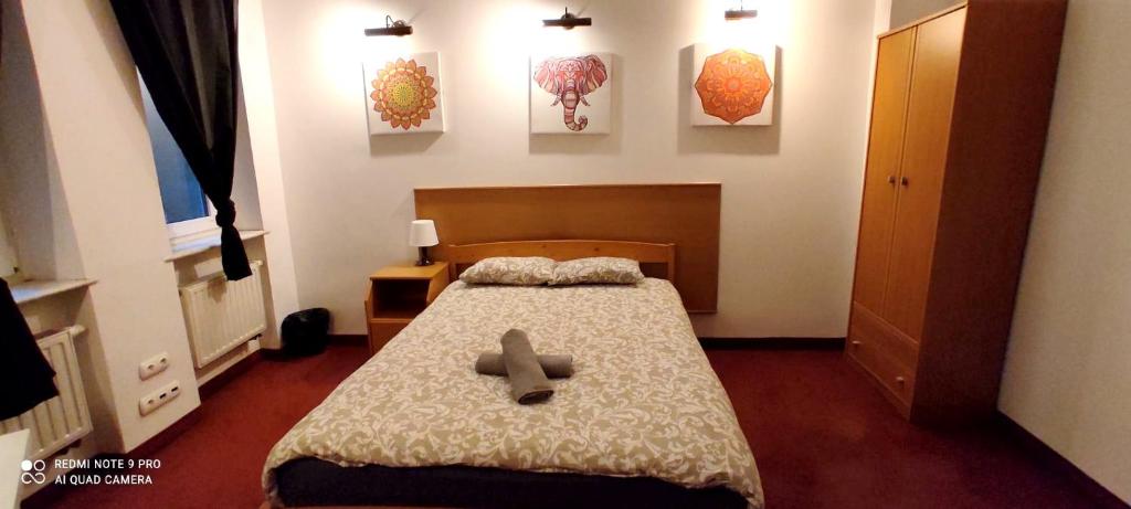 a room with a bed with a cross on it at Mandala Hostel in Poznań