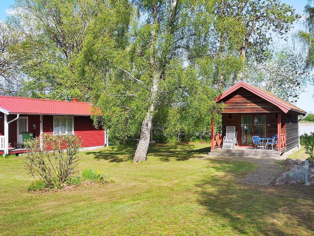 a small red cabin with a porch and a yard at 4 person holiday home in Mörbylånga-By Traum in Mörbylånga