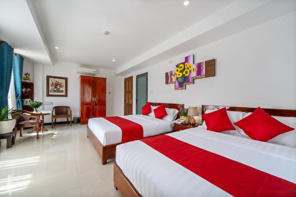Giường trong phòng chung tại Gioan Boutique Villa