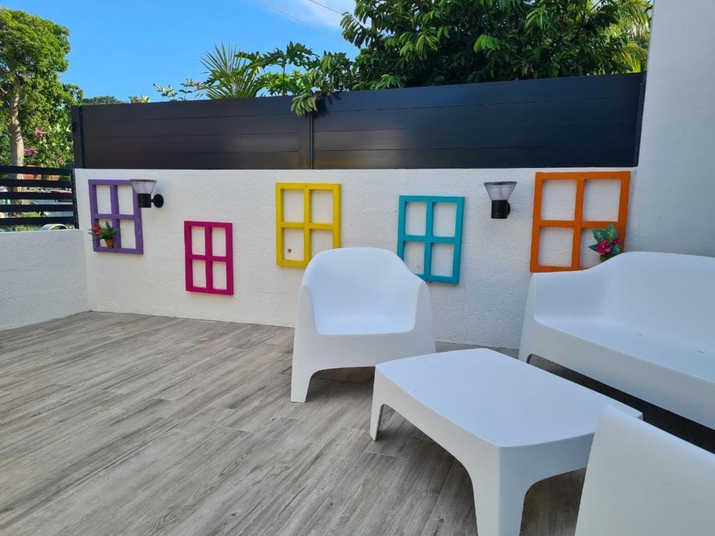 a toy house with colorful windows on a patio at Ti Kaz Marigot in Terre-de-Haut