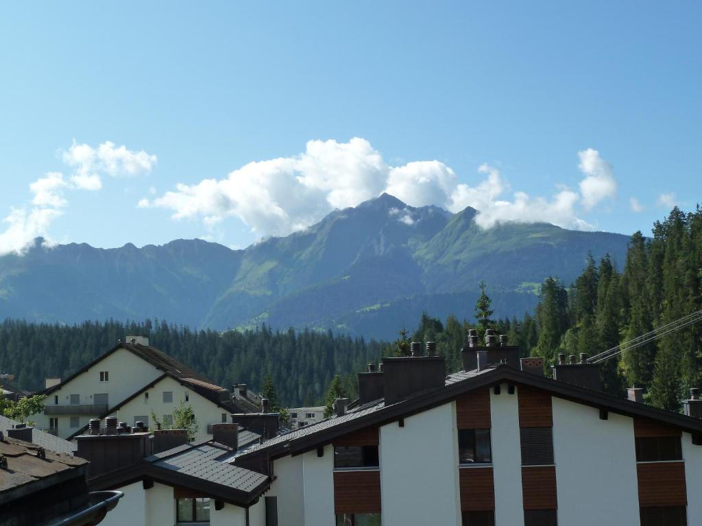 a view of the mountains from a town with houses at Ferienwohnung Murschetg in Laax