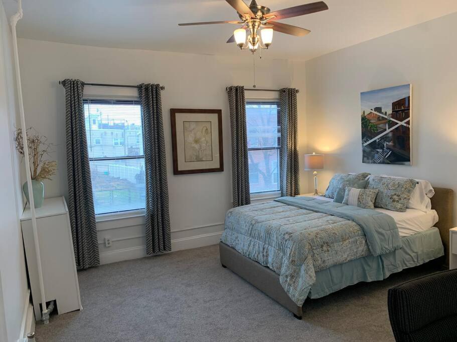 a bedroom with a bed and a ceiling fan at Stylish 2BD/1BA apartment located in Federal Hill in Baltimore