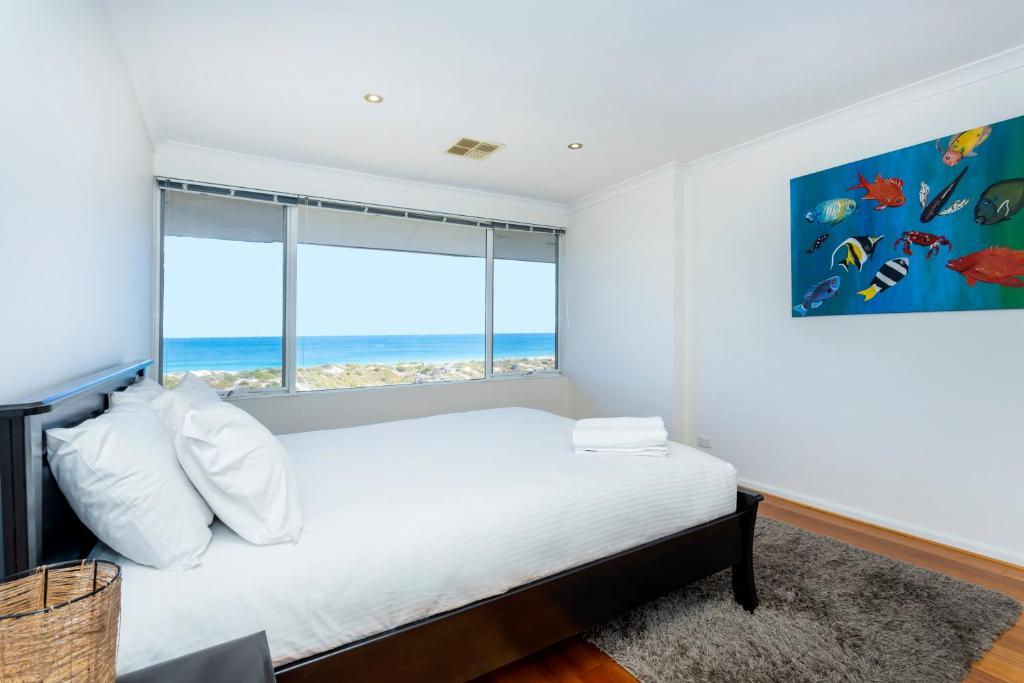 a bedroom with a bed and a large window at Scarborough Beachlife Apartment - Executive Escapes in Perth