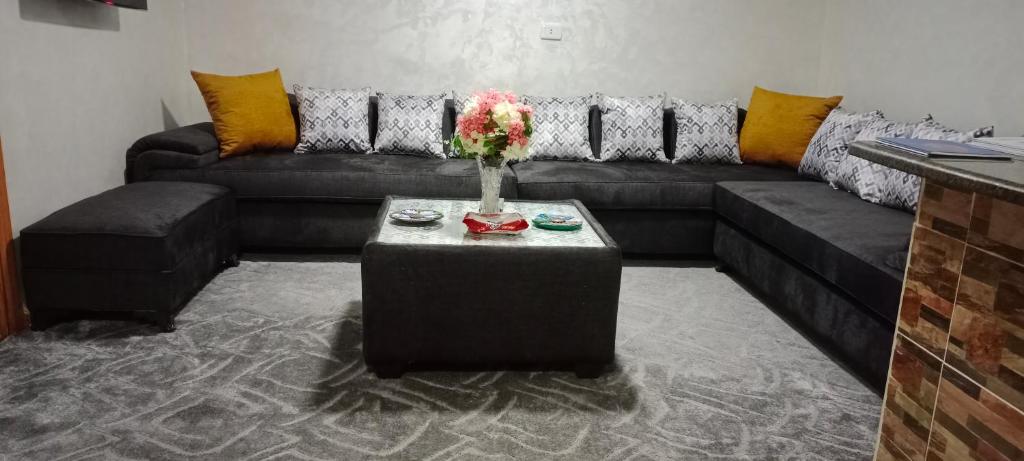 a living room with a couch and a table at Apartment private entrance with terrace for rent close to services and city center in Amman