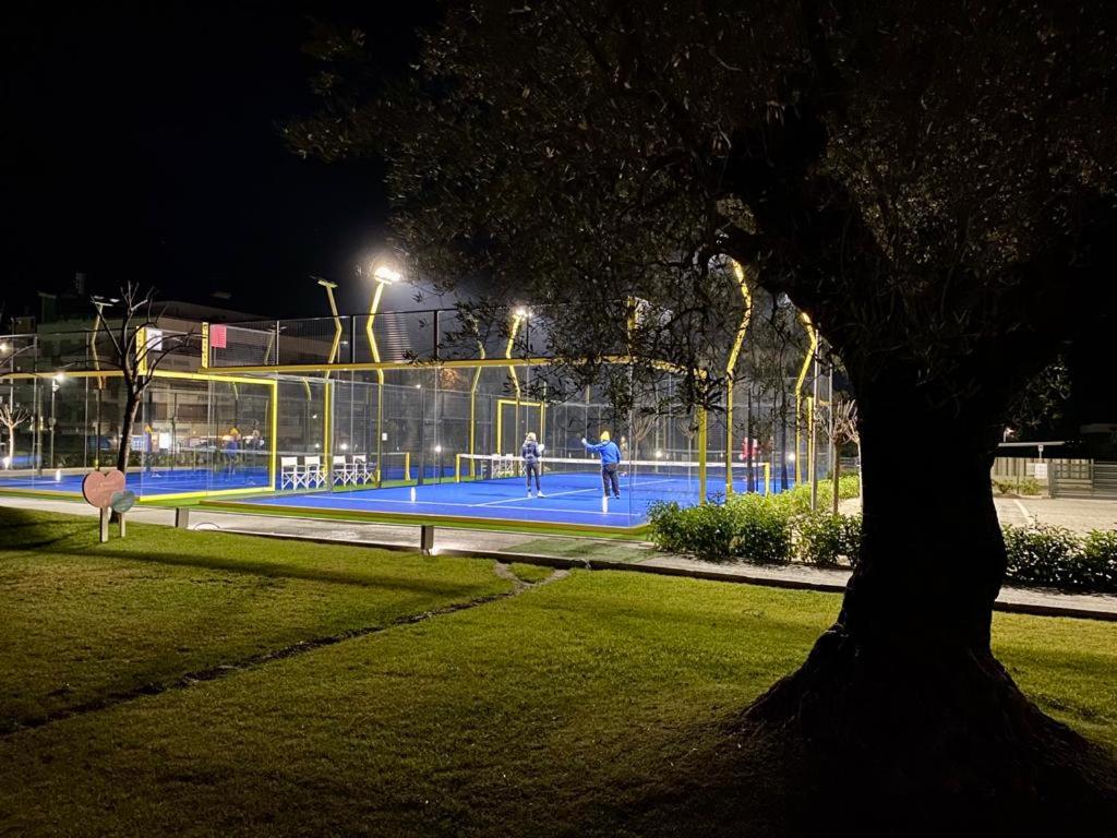 a tennis court in a park at night at YOUMAMI Suite Hotel Wellness&Spa in Giulianova