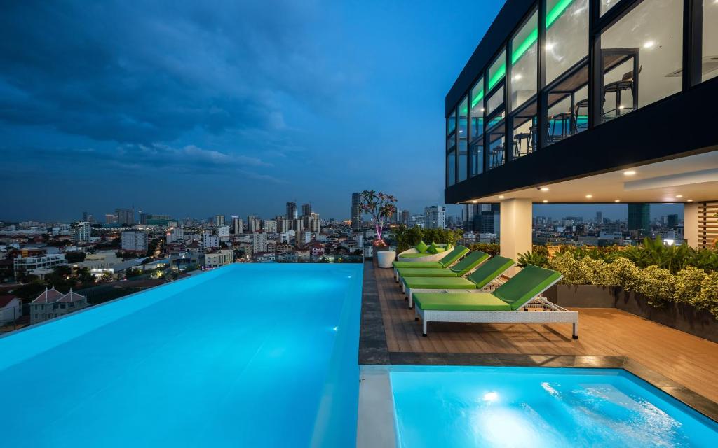 a pool on the roof of a building with a view at AMATA Residence in Phnom Penh
