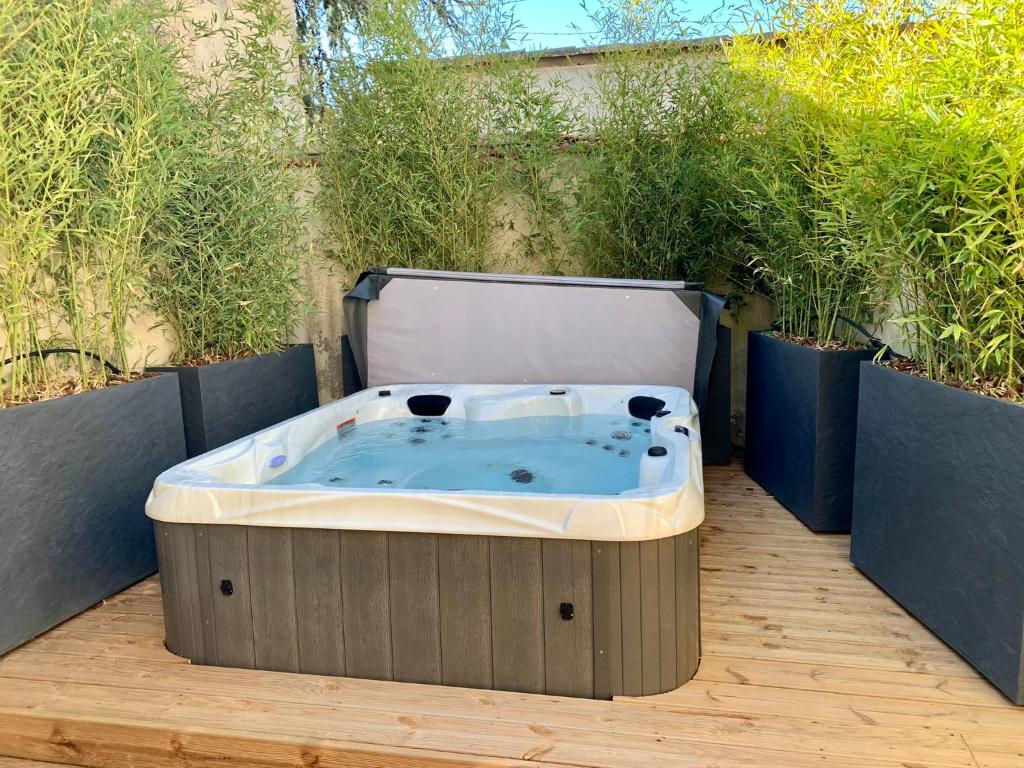 a jacuzzi tub sitting on a wooden deck at Dans ma Bulle - Les Balcons de la Cité in Carcassonne