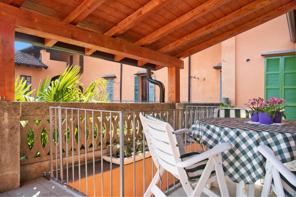 a patio with a table and chairs on a balcony at Appartamento Andrea in Germignaga