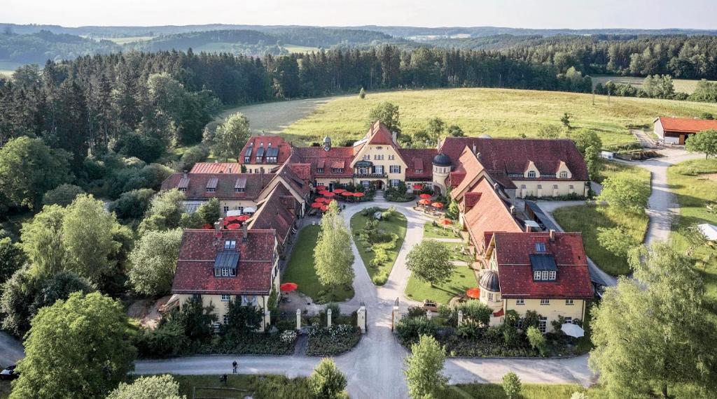 an aerial view of a large house with red roofs at Gut Sonnenhausen in Glonn