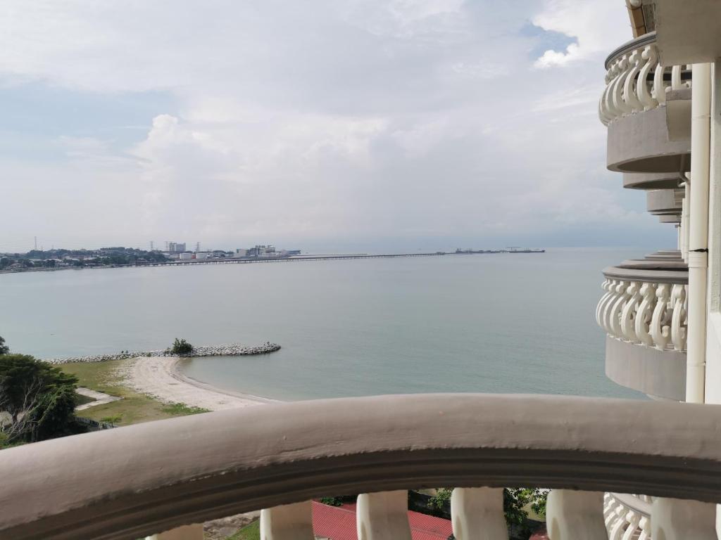 a view of the ocean from the balcony of a building at Beach View Private Apartment in Port Dickson