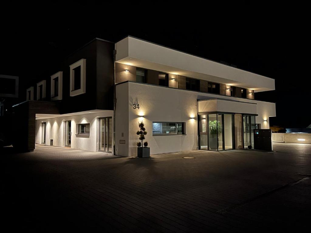 a large white building at night with lights at Apartment34 in Öhringen