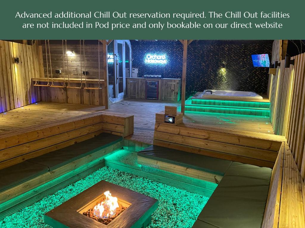 an outdoor hot tub with a fire in the middle at Orchard Hideaways in Penrith