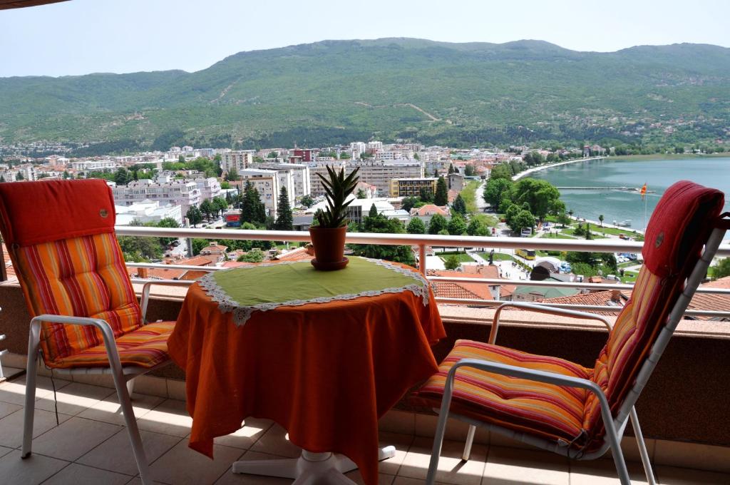 einen Tisch und Stühle auf einem Balkon mit Aussicht in der Unterkunft Lakeview Apartments Ohrid in Ohrid