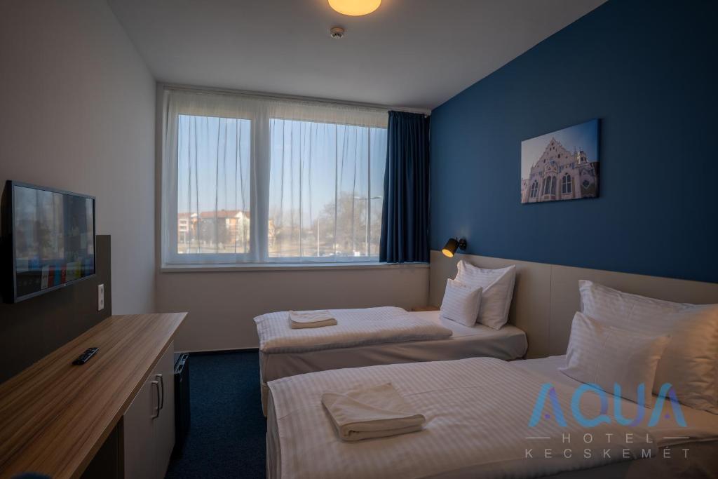 TV a/nebo společenská místnost v ubytování Aqua Hotel