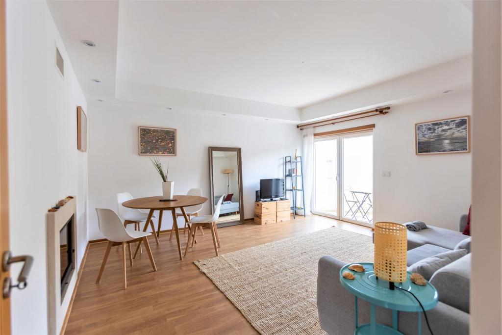 a living room with a couch and a table at Spacious Beach Flat in Costa Caparica by Soulplaces in Costa da Caparica