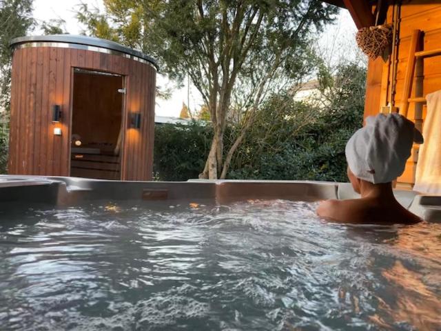 a person in a jacuzzi in a hot tub at Wellness Bungalow Bolder 5p Amsterdam and the beach in Opmeer