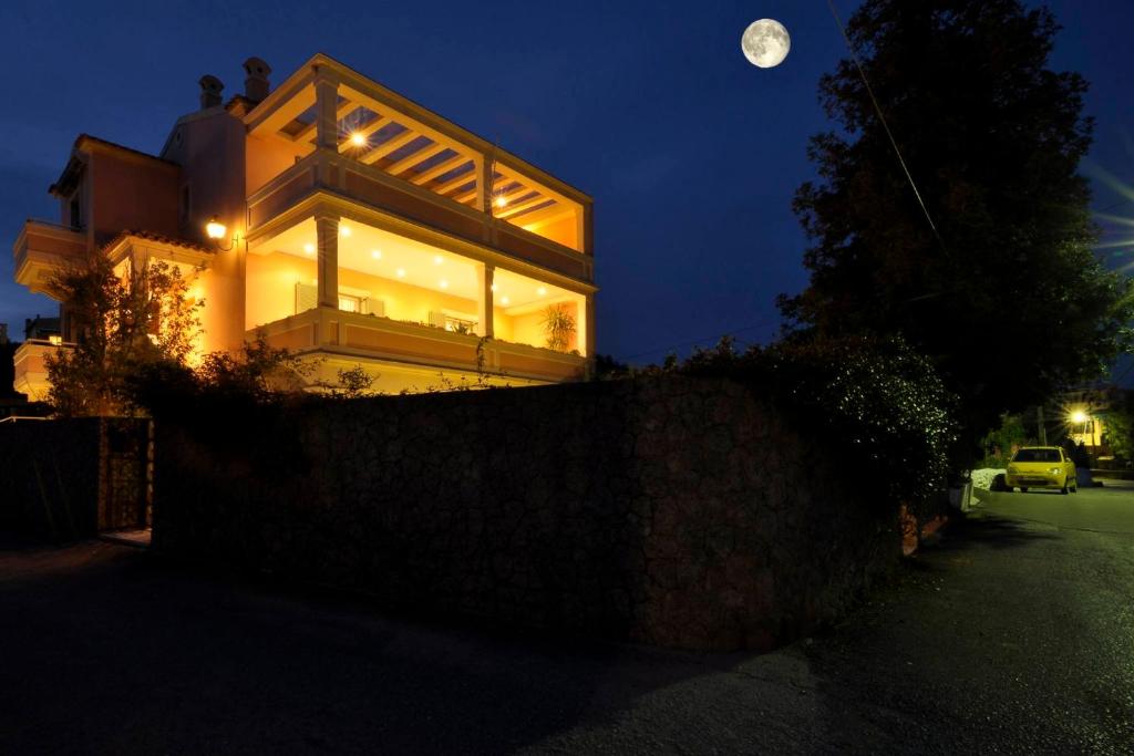 een huis 's nachts met de maan in de lucht bij Piano House by Corfuescapes in Corfu-stad