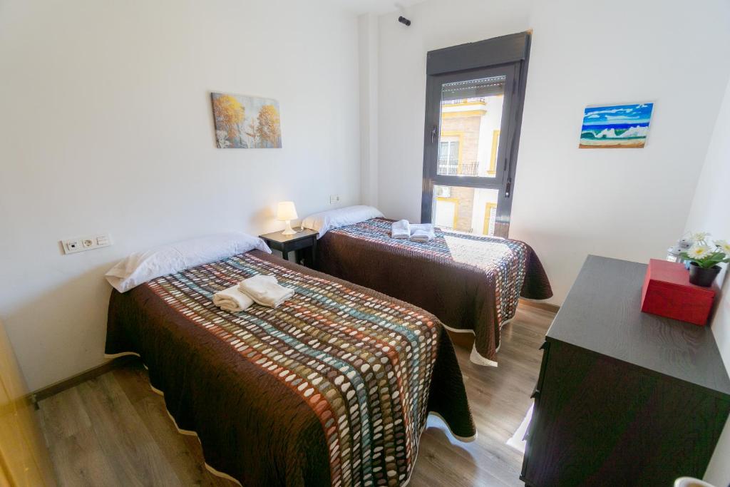 A bed or beds in a room at RentalSevilla Virgen de Loreto