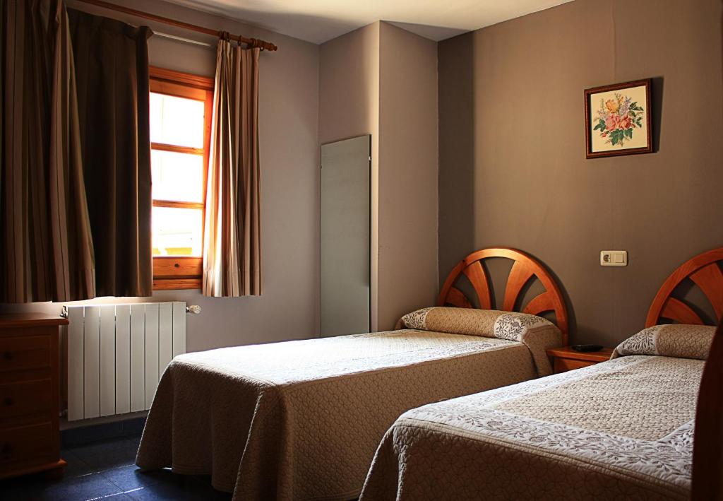 Postel nebo postele na pokoji v ubytování Hostal Casa Lacreu